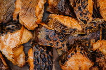 limbazi, Latvia, June 29, 2024 - Close-up of grilled salmon pieces with charred skin and a golden-brown texture. The salmon appears crispy and well-cooked.
