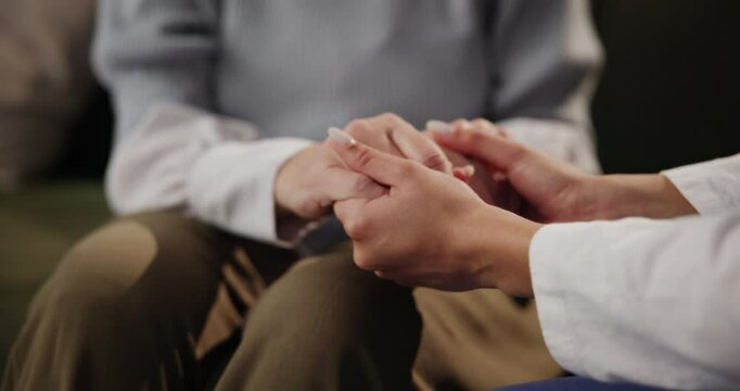 People, helping and holding hands for care, comfort and support with medical news or mental health in psychology. Psychologist, therapist or counselor with kindness and empathy for patient counseling