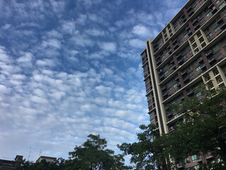 High rise residential building under cloudy blue sky at Thailand.