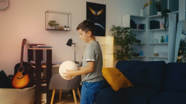 Young boy playing with soccer ball at home, sports hobby, active lifestyle