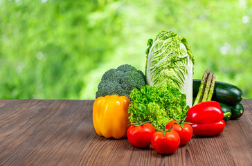 Harvest of fresh raw vegetables on a wooden table, free space.
