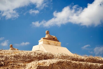 Sphinx statue in Alexandria against the background of a blue sky. Egypt