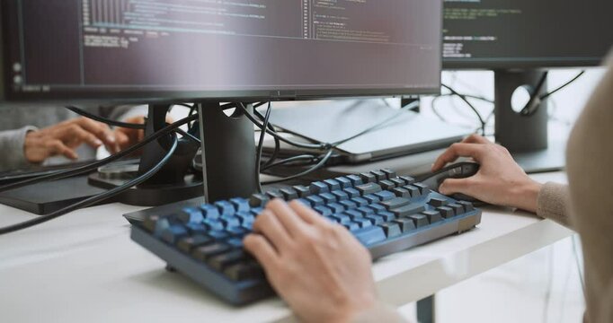 Young adult Asian male, female software developer coding program on desktop computer. Man, woman work from home, remote working, freelance programmer job, smart digital nomad lifestyle concept