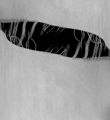 hanging teared rag spread isolated on black background , can use like a background or any texture....