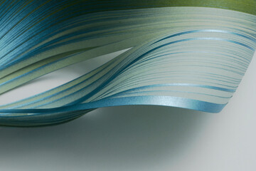 Silver, blue, color strip gradient wave paper on gray. Abstract texture background.