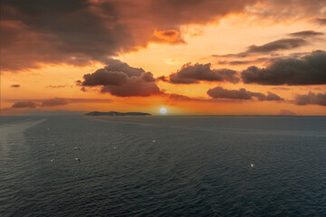 Seascape. A small island in the sea. Setting sun. Colorful sky evening sea landscape