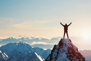 A businessman stands triumphantly on a mountain peak with copy space