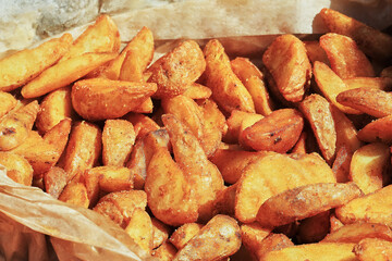 Crispy Fried Potato Wedges in a Brown Paper Bag