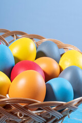 easter basket with straw and colored eggs
