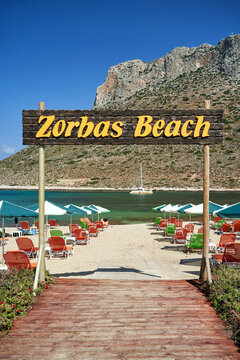 Deckchairs and umbrellas on the sandy beach of Zorbas in the town of Stavros on the island of Crete