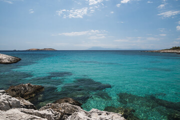 Fototapeta premium Beautiful turquoise blue sea along the rocky coast of Atspas beach on the island of Thasos in Greece