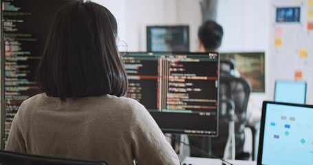 Young adult Asian male, female software developer coding program on desktop computer. Man, woman work from home, remote working, freelance programmer job, smart digital nomad lifestyle concept - Powered by Adobe