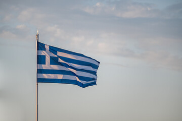 Fototapeta premium The Greek flag is flying on the banner
