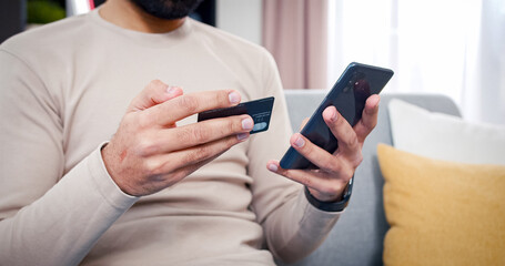 Close up portrait of male hands with phone and bank card. Man makes online purchases binding bank card number to device.