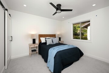 Modern bedroom interior with a neatly made bed.