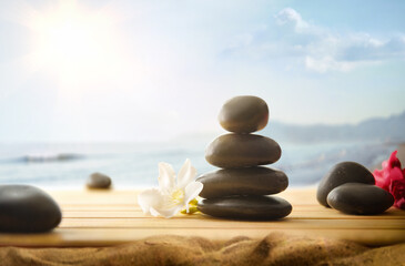Health and body care with stones on wooden and beach
