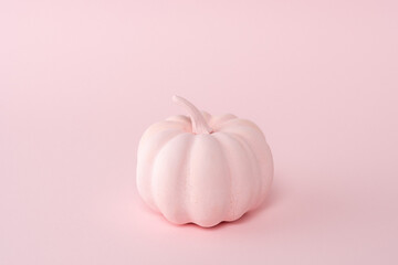 Pink pumpkin on a pastel pink background. Minimal Halloween concept.