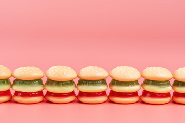 Colorful candy hamburgers on pink background. Minimal food concept.