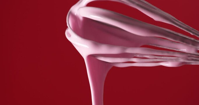 A corolla with pink cream on it on a homogeneous red background.
