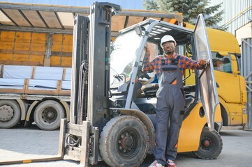 African American Man at work. Professional operation engineering. Young worker forklift driver