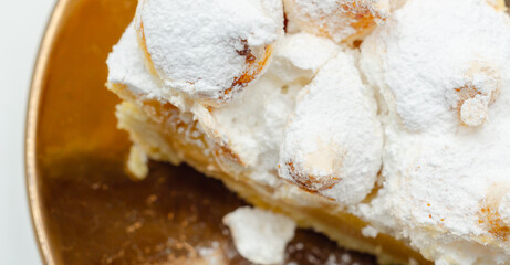 A slice of pie with a lot of powdered sugar on top