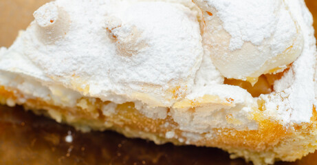 A slice of pie with a lot of powdered sugar on top