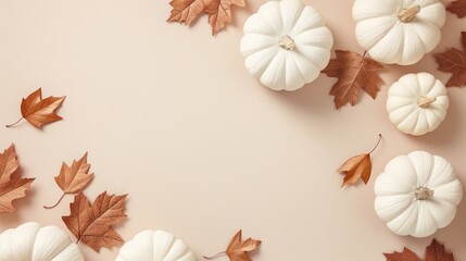 Elegant white pumpkins with brown autumn leaves on a warm beige background, ideal for autumn-themed promotions