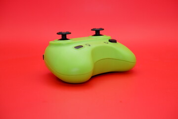 rc airplane controller isolated on red background. close up of the green rc controller