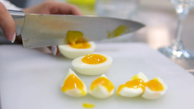 Cutting a soft-boiled egg in close up