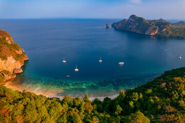 Aerial view Jungle with sunrise on Phi Phi with white yacht catamaran in Thailand. Concept trip...