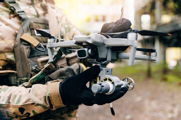 Modern drone with reset device for bomb in hands of soldier army. Military UAV use in war