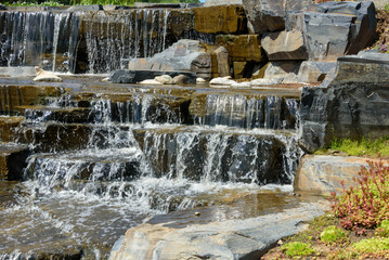 Close-up of water flowing down large stones in the cascading waterfall.