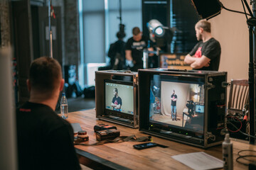 Film set, monitors and modern shooting equipment. Film crew, lighting devices, monitors, playbacks - filming equipment