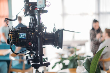 Professional film and video camera on the set. Shooting shift, equipment and group.