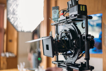 Professional film and video camera on the set. Shooting shift, equipment and group.