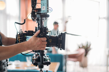Professional film and video camera on the set. Shooting shift, equipment and group.