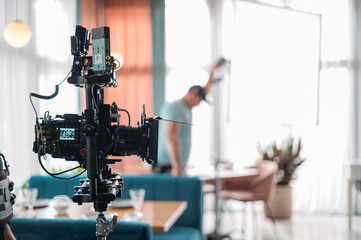 Professional film and video camera on the set. Shooting shift, equipment and group.