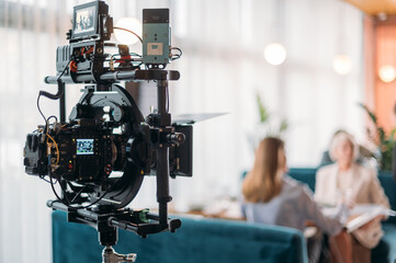 Professional film and video camera on the set. Shooting shift, equipment and group.