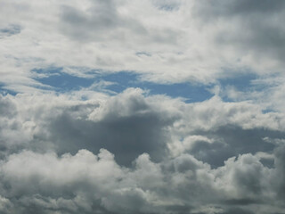 The sky is blue with a few clouds scattered throughout. The clouds are white and fluffy, giving the sky a peaceful and serene appearance