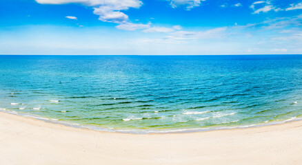 panoramic drone view of waves crashing on beach