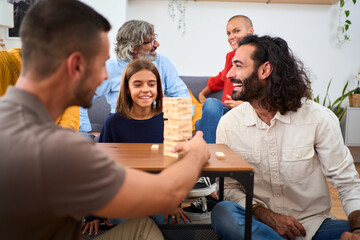 Relaxed people digital detox sharing quality time at home. Happy family together in the living room talking quietly. Positive and cheerful domestic relationships and board games at the weekend