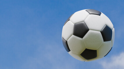 soccer ball in the air by kick on a day with blue sky and clouds, sports and exercise theme