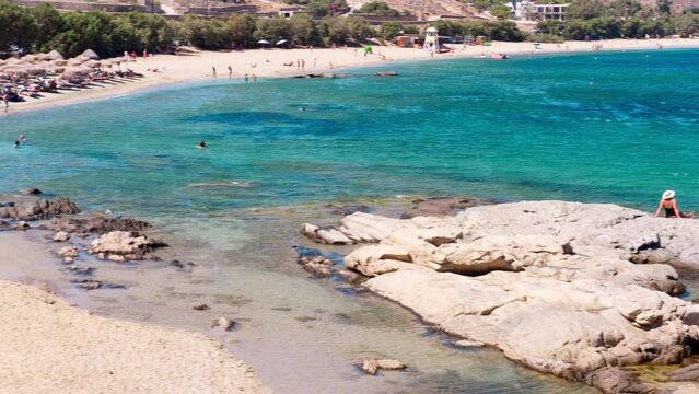 Kalafatis Beach in Mykonos, Greece. Kalafati is the beach most loved for water sports such windsurf, kitesurf, diving and snorkeling. Near the awesome view of Dragnoisi Island and Divounia,