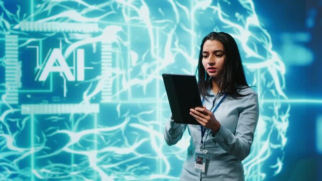 Developer using tablet to implement artificial intelligence parallel processing, breaking up complex computational tasks enabling AI systems to process more input data faster, camera A
