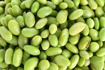 Raw green edamame soybeans as background, top view