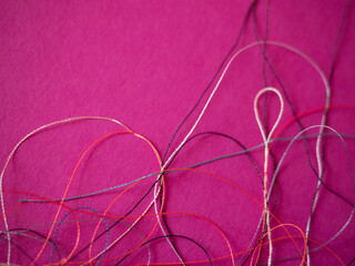 Chaotically tangled threads. Embroidery threads randomly woven. Huge knot. Extreme macro. Beautiful...