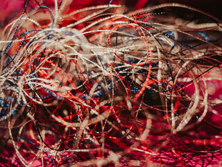 Chaotically tangled threads. Embroidery threads randomly woven. Huge knot. Extreme macro. Beautiful...