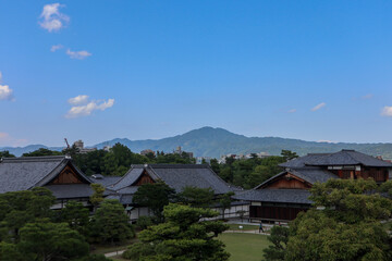 Background landscape of the beauty of Nijo Castle in Kyoto with a clear sky and mountains and trees in summer. nuances of ancient Japanese architecture