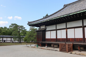 Background landscape of the beauty of Nijo Castle in Kyoto with a clear sky and mountains and trees in summer. nuances of ancient Japanese architecture