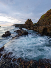 Beautiful rocky coastline with flowing water in the morning.